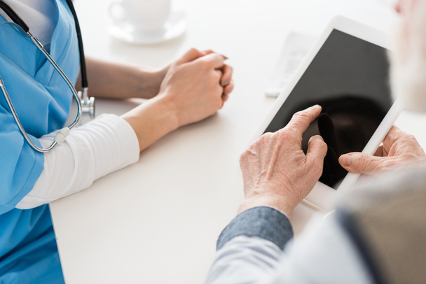 Cropped view of hands pointing at digital tablet with blank screen - Fotoğraf, Görsel