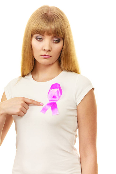 Woman sad girl wih pink cancer ribbon on chest  - Фото, изображение