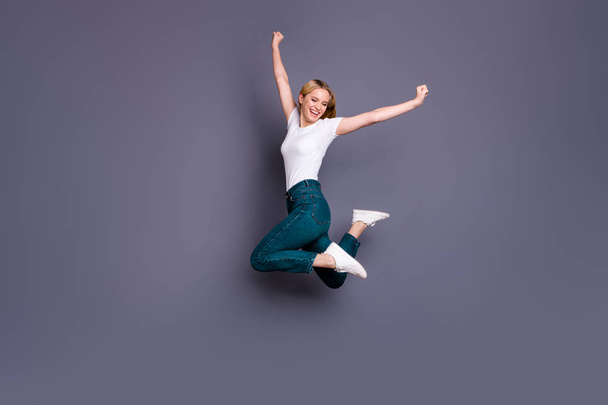 Full length body size view photo of content positive nice lady raise fists scream yeah achieve celebrate aim champion sport fans isolated dressed sneakers clothes grey background - 写真・画像