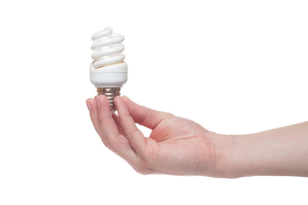 Hand holding Illuminated light bulb isolated on white background - Фото, изображение