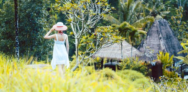 Woman in tropical vacation walking through the jungle - Photo, Image
