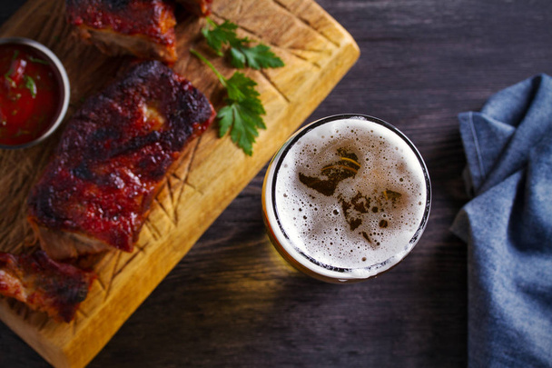 Beer and pork spare ribs. Ale and meat. Beer and food concept - Image - Fotoğraf, Görsel