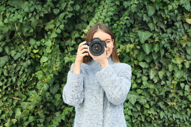 Young female photographer outdoors - Фото, зображення