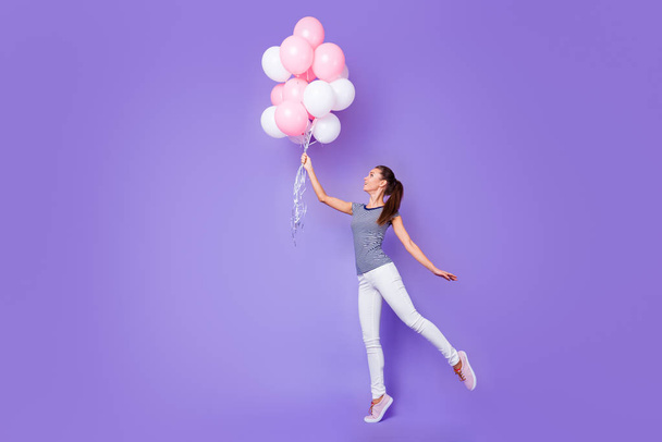 Full length body size view portrait of her she nice-looking attractive lovely charming cheerful cheery girl dancing with helium balls isolated over violet purple vivid shine bright background - Fotoğraf, Görsel