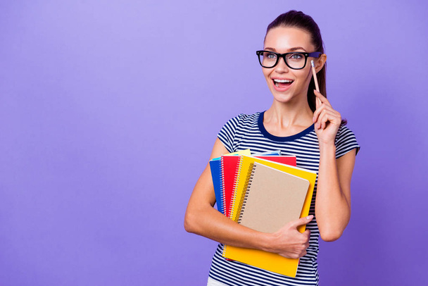 Portrait of her she nice-looking attractive lovely charming cute intelligent cheerful cheery girl holding in hands books pointing pencil isolated over violet purple vivid shine bright background - Φωτογραφία, εικόνα