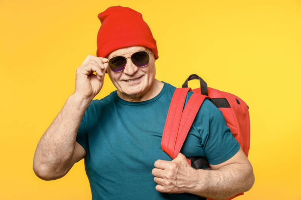 Portrait of stylish senior man on color background - 写真・画像
