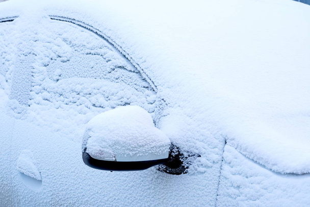 part of the white car in the snow only sticks - Photo, image