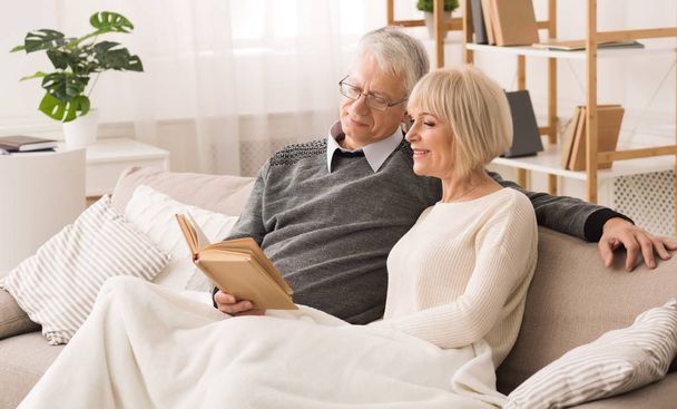 Resting Together. Happy Senior Couple Reading Book - 写真・画像