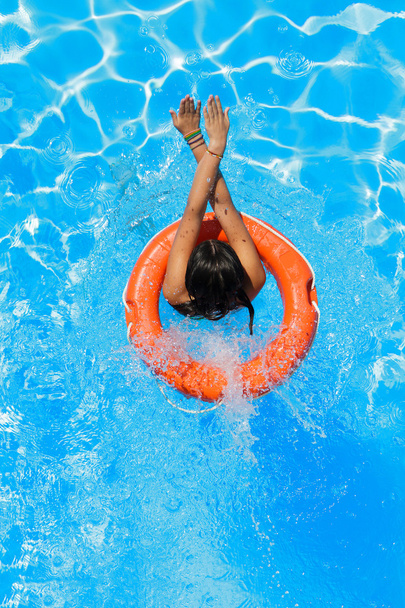 jumping in the buoy at the swimming pool - Foto, Imagen