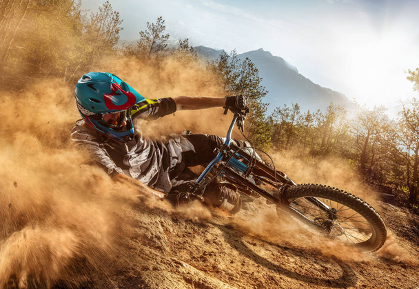 Mountain biker on forest trail. Male cyclist rides the rock - Photo, Image