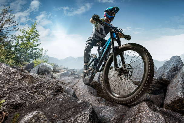 Mountain biker on stone trail. Male cyclist rides the rock - Photo, Image