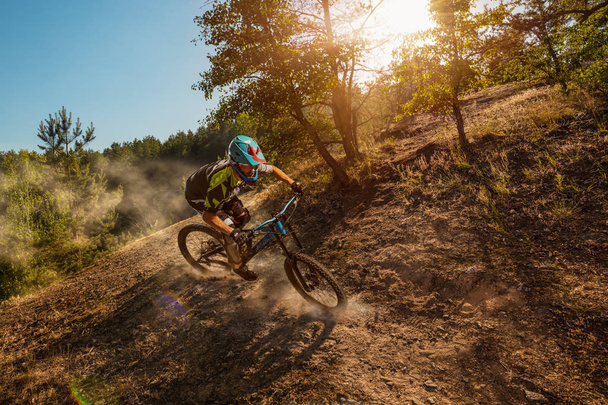 Mountain biker on forest trail. Male cyclist rides the rock - Photo, Image