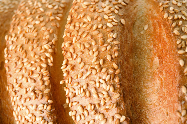 Tasty bread with sesame seeds as background, closeup - Foto, immagini