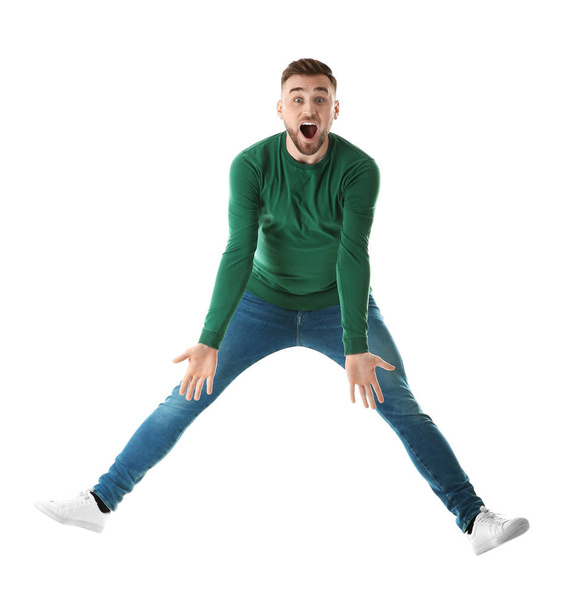 Full length portrait of emotional man jumping on white background - Foto, imagen