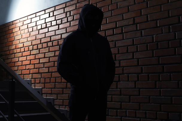 Silhouette of mysterious man in hoodie indoors. Dangerous criminal - Fotoğraf, Görsel