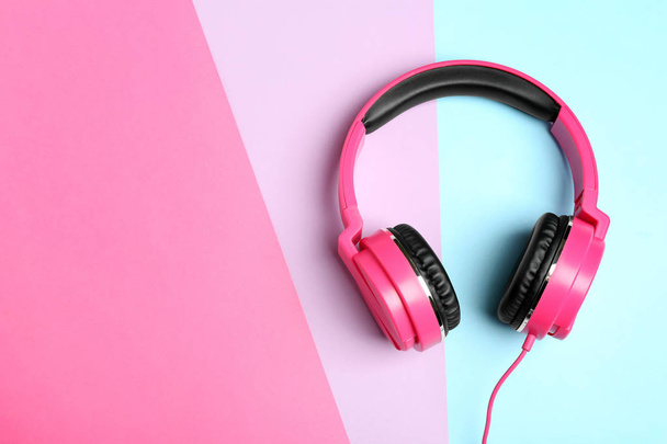 Stylish headphones on color background, top view. Space for text - Foto, imagen