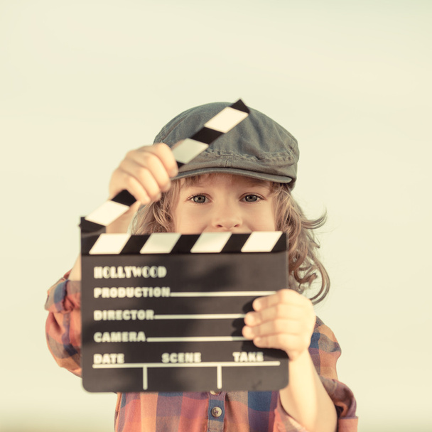 Kid holding clapper board in hands - Photo, Image