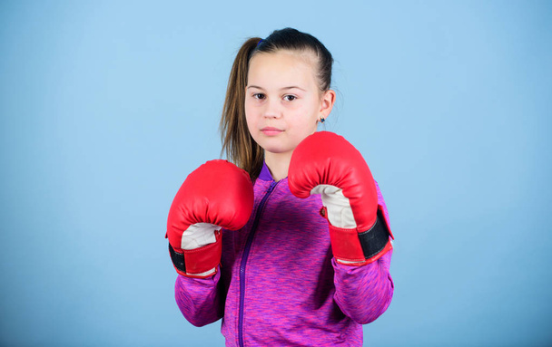 Girl cute boxer on blue background. With great power comes great responsibility. Contrary to stereotype. Boxer child in boxing gloves. Female boxer. Sport upbringing. Boxing provide strict discipline - Fotó, kép