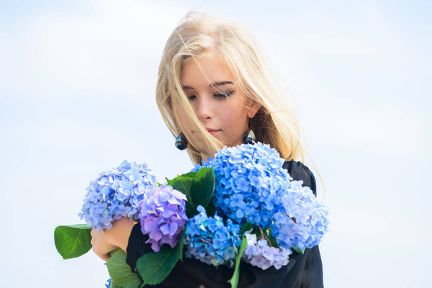 Skin care and beauty treatment. Gentle flower for delicate woman. Pure beauty. Tenderness of young skin. Springtime bloom. Girl tender blonde hold hydrangea flowers bouquet. Natural beauty concept - Фото, зображення