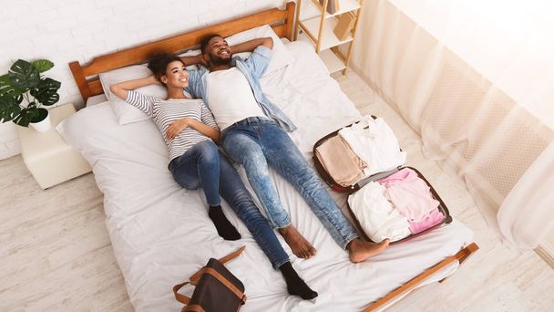 Ready For Journey. Couple Lying On Bed - Valokuva, kuva
