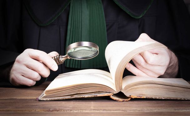 Criminal or tax investigation concept. Hand with detective magnifying glass - Photo, image