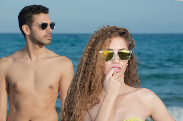 Beautiful couple near the sea with bikini in summer - Photo, Image