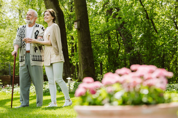 Garden of the nursing home and nurse with patient - 写真・画像