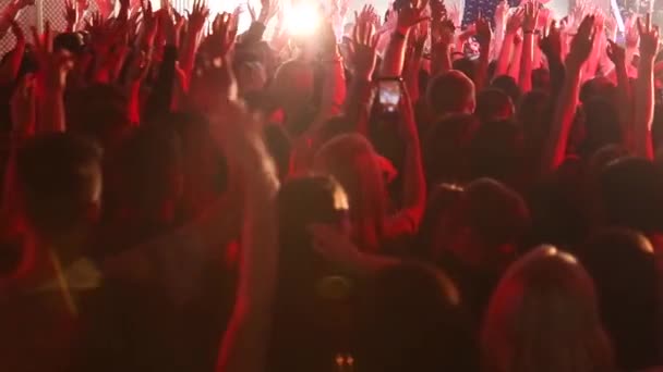 Audience with hands raised at a music festival. Concert crowd at live music festival - Footage, Video
