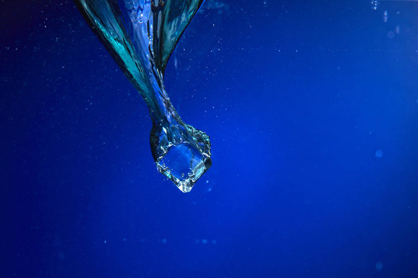 ice cube falling into water, close-up  - Zdjęcie, obraz