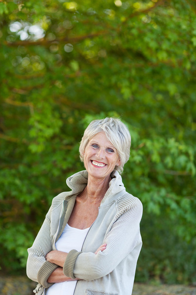 Senior Woman With Arms Crossed Standing In Park - Photo, image