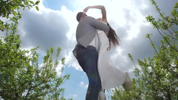 Alegre pareja pasando el ocio en huerto de primavera
 - Imágenes, Vídeo