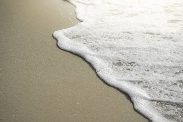 sea wave with bubbles on the sand beach  - Foto, immagini
