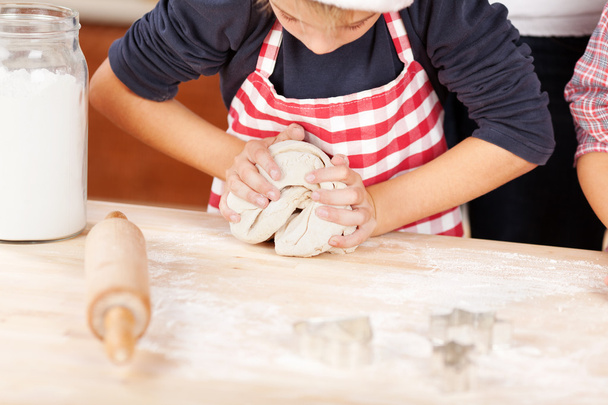 Boy Kneading dough for cookies - Zdjęcie, obraz