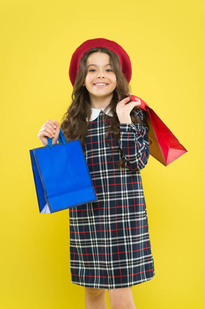Rediscover great shopping tradition. Shopping and purchase. Black friday. Sale discount. Where fashion comes to life. Shopping day. Happy child hold packages. Girl with shopping bag. Save money - 写真・画像