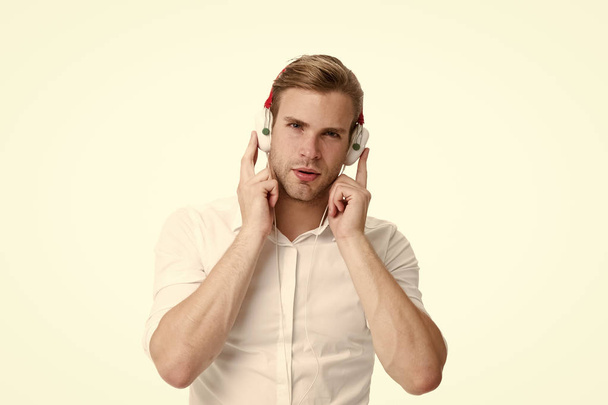 Ebook has to happen. Man listen to music in headphones. Handsome man listening to business ebook. Music fan. The rule of my life is to make business a pleasure - Photo, Image