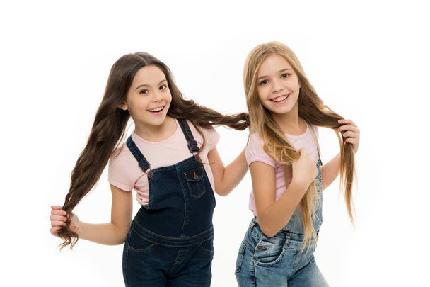 Being great every day. Adorable small girls with long hair. Cute little girls wearing new hairstyle. Kids hair care and grooming. Beauty and hair salon. Natural hair styling and dressing - Foto, Bild