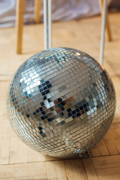 Mirror disco ball laying on the floor - Фото, изображение