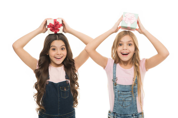 Learned how to gift wrap. Happy little girls holding gift boxes over head. Small children with gift packs on boxing day. Adorable kids with beautifully wrapped birthday gift boxes - Zdjęcie, obraz