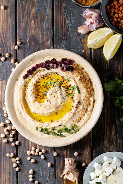 Hummus met olijfolie en gemalen komijn - Foto, afbeelding