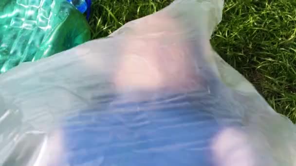 Kadın plastik bir torbanın içinde yatıyor. Plastik kirliliği - Video, Çekim