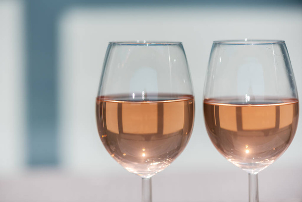 Two glasses of rose wine on a wooden table - Фото, зображення