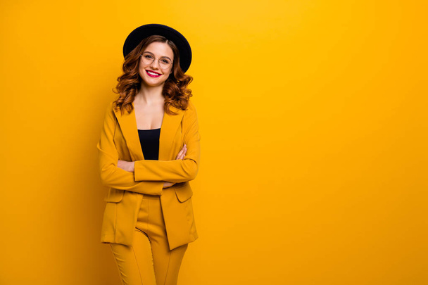 Portrait of her she nice-looking charming cute attractive winsome lovely chic elegant cheerful wavy-haired lady in yellow jacket blazer folded arms isolated on bright vivid shine orange background - Photo, image