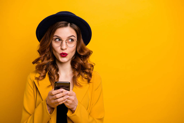 Close up photo beautiful she her lady watch sly tricky side empty space arms hands telephone reader cool news modern look wear specs formal-wear costume suit isolated yellow vibrant background - 写真・画像