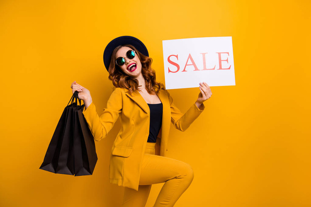 Close up side profile photo beautiful she her lady recommend black friday packs paper promo low prices buy buyer sale discount wear specs formal-wear costume suit isolated yellow bright background - Photo, image