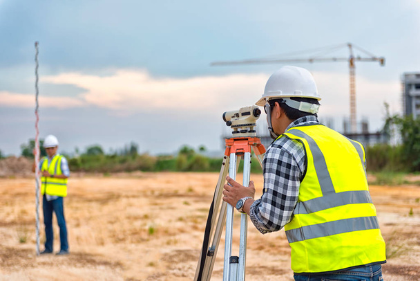Surveyor equipment. Surveyors telescope at the construction site or Surveying for making contour plans are a graphical representation of the lay of the land before startup construction work - Photo, Image