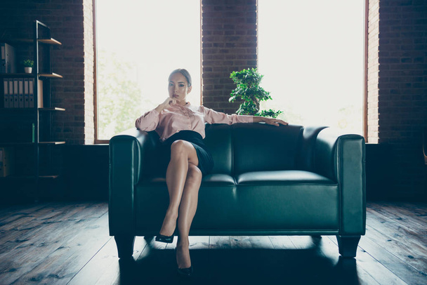 Portrait of nice attractive elegant stylish confident content bossy chic lady shark specialist sitting on couch at modern industrial loft interior style work place station indoors - Foto, Bild
