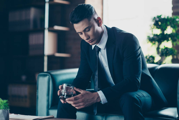 Close up side profile photo handsome he him his pensive ponder hands arms whisky beverage eyes closed enjoy wear formal-wear dress code shirt jacket tie suit costume sit chair indoors office place - Photo, Image