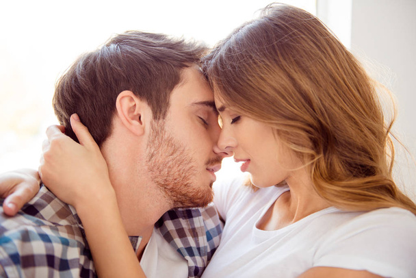 Close-up portrait of his he her she nice-looking caucasian sweet attractive charming bearded guy kissing lady life partners in light white style interior hotel house indoors - Photo, image