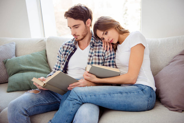 Portrait of his he her she nice-looking attractive cute charming focused concentrated calm peaceful couple morning sitting on cosy divan in light white style interior living room house indoors - Foto, immagini