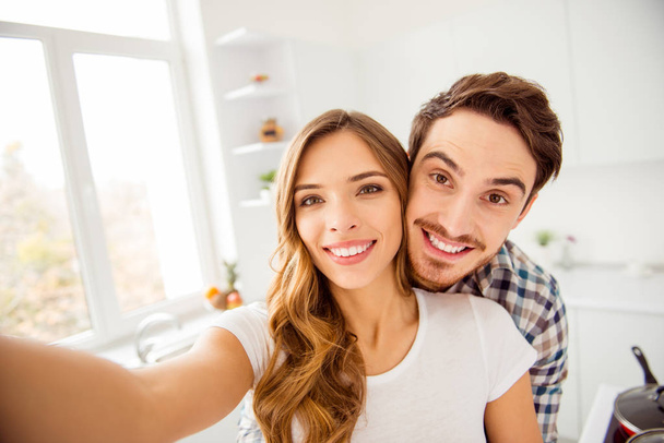 Close up photo pair beautiful amazing funky pair he him his macho she her lady just married honeymoon overjoyed piggy back pose make take selfies bonding apartments flat bright kitchen indoors - Photo, image